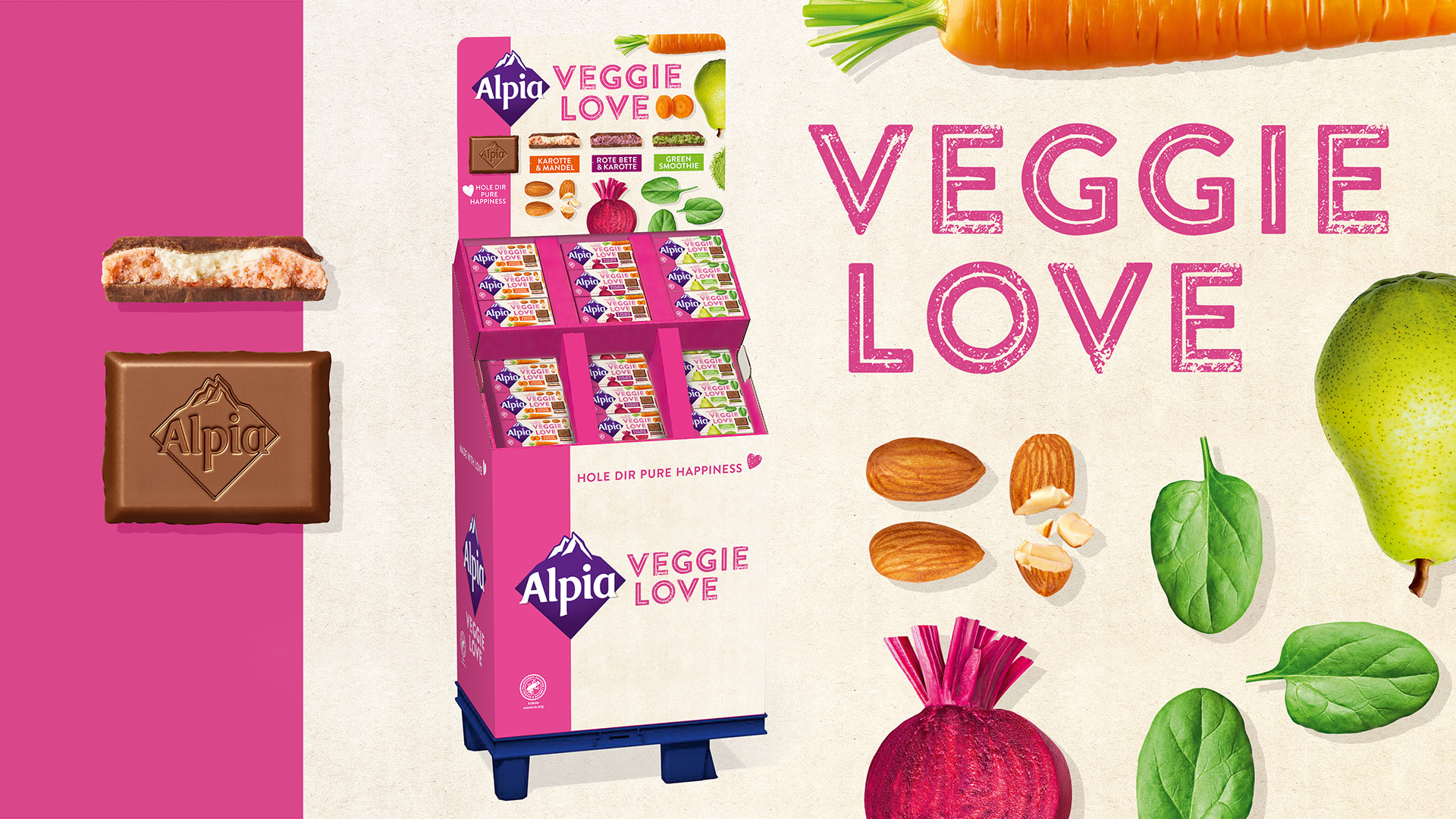 Alpia Veggie Love Schokolade mit Gemüse und Nüssen in pinkem Display – Mix aus Genuss und pflanzlicher Vielfalt.